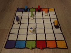 a crocheted board game on the floor