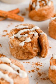 cinnamon rolls with icing and cinnamon sticks