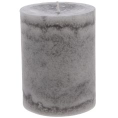 a candle that is sitting on top of a white surface with a light in the middle