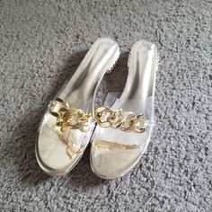 New Clear Slip On Sandals With Gold Accents. Size 41 #Goldchain #Nwt #Sandals I'm Willing To Negotiate Prices And I Give Discounts On Bundles. Free Shipping On Larger Bundles As Well! Any Questions Just Ask I'm Here To Help :) Items Are Cross Posted So Dont Hesitate To Buy! Vacation Sandals With Chain Strap And Round Toe, Vacation Sandals With Chain Strap And Synthetic Material, Synthetic Sandals With Chain Strap For Vacation, Vacation Sandals With Chain Strap, Summer Sandals With Chain Strap And Open Toe, Gold Jelly Sandals With Round Toe For Spring, Flat Sandals With Chain Strap And Synthetic Material, Open Toe Sandals With Chain Strap, Beach Sandals With Chain Strap For Summer