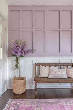 a wooden bench sitting in front of a purple wall with paneling on the walls