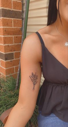 a woman with a flower tattoo on her left arm and right arm behind her back