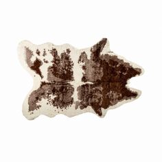 a brown and white cowhide rug on a white background