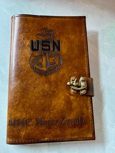 a brown leather book with an emblem on it