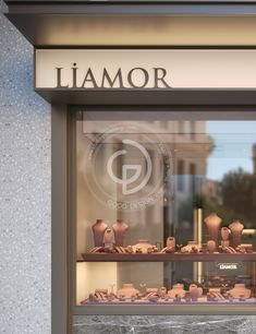 a store front window with vases and pottery on display