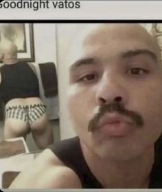 a man with a moustache is taking a selfie