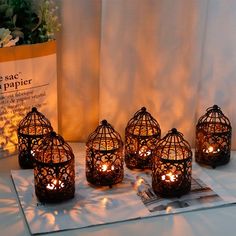 four lit candles are sitting on a table