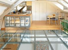 an attic kitchen and dining area with glass flooring