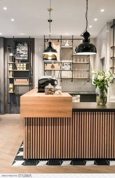 a kitchen with wooden counter tops and hanging lights