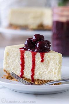 a slice of cheesecake with cherries on top