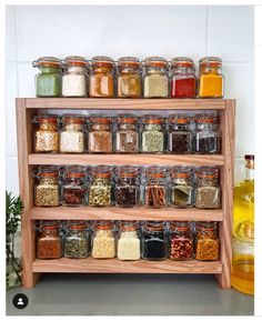 a wooden spice rack filled with lots of different types of spices