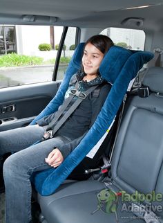 a woman sitting in the back seat of a car