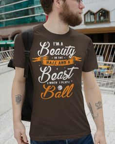 a man wearing a green t - shirt that says i'm a beauty in the best when i have ball