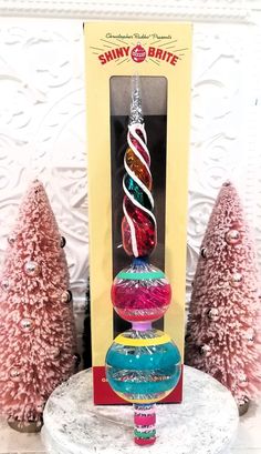 a glass ornament in the shape of a christmas tree