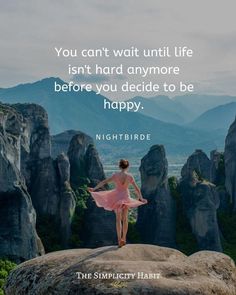 a woman in a pink dress standing on top of a rock formation with the quote you can't wait until life isn't hard anymore before you decide to be happy