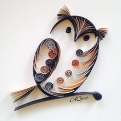 a metal bird with swirls on it's wings