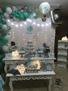 a table topped with lots of cake and balloons