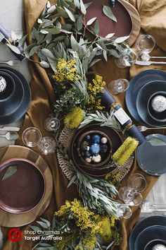 the table is set with dishes and place settings