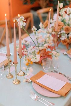 the table is set with candles and place settings