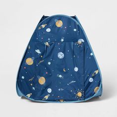 a blue backpack with planets and stars on the front, sitting in front of a white background