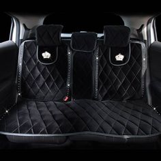 the back seats of a car with chandelier quilting on them and black carpet