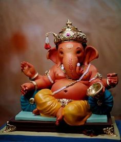 an elephant statue sitting on top of a blue table