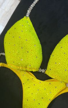 a pair of yellow bikinisuits with silver beads