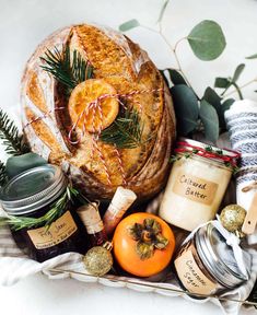 a basket filled with bread, jams and other items