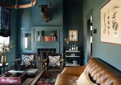 a living room filled with furniture and a deer head mounted to the side of the wall