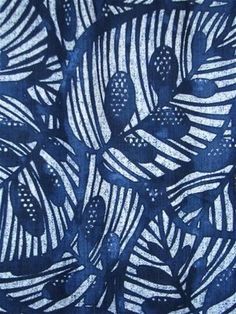 a blue and white print fabric with leaves on the front, in shades of indigo blue