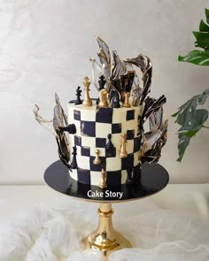 a black and white cake with chess pieces on it