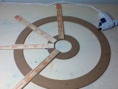 several pieces of cardboard sitting on top of a white surface next to an electric toothbrush