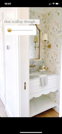 the bathroom is decorated in white and has floral wallpaper on it's walls