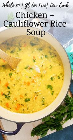 chicken and cauliflower rice soup in a white bowl with a wooden spoon next to it