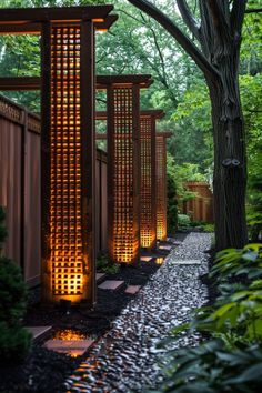 an outdoor garden with wooden gates and lights