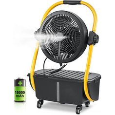 an electric fan sitting on top of a cart next to a battery