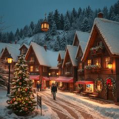 people walking down a snow covered street with christmas decorations on the buildings and trees around them