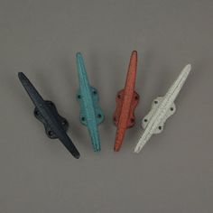 four different colored handles on a gray surface