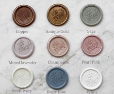 six different types of wax seals on a marble surface