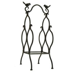 an iron shelf with two birds on it