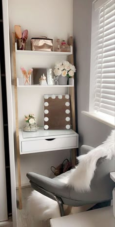 a white desk and chair in a small room with shelves on the wall above it