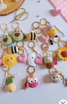 a bunch of key chains that are made to look like crocheted animals and birds