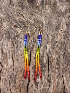 Simple, dainty beaded earrings in a beautiful rainbow ombre color scheme! The earring hooks are 14k gold filled, which makes them safe for most sensitive ears. These are lightweight and should be suitable for everyday wear.  Length is about 3 inches. Care Instructions: To keep your earrings looking their best, store them in a dry place away from moisture. Please remove all jewelry before swimming or showering. Please visit my shop for other great listings!  Message me with any questions and thank you for visiting my shop! Rainbow Ombre, Ombre Color, Boho Gifts, Earrings Minimalist, Beautiful Rainbow, Seed Bead Earrings, Earring Hooks, Earrings Boho, Bead Earrings