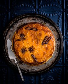 an overhead view of a pie on a plate with star decorations and cinnamon sticks around it