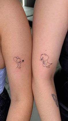 two people with matching tattoos on their arms, one has a small mouse tattoo on the other arm