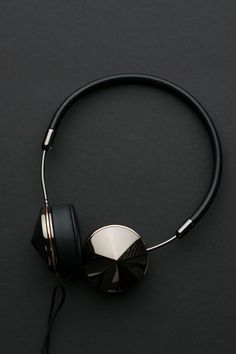 a pair of headphones sitting on top of a black table next to each other