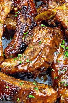 barbecue ribs with bbq sauce and parsley on the side, ready to be eaten