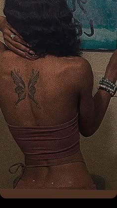 the back of a woman with tattoos on her body