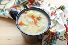 a cup filled with soup sitting on top of a table