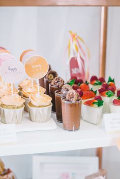 cupcakes and pastries are on display at a birthday party or brunch